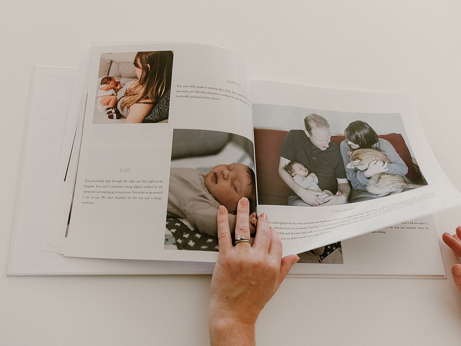 A person shows examples of what to write in a book for a newborn.