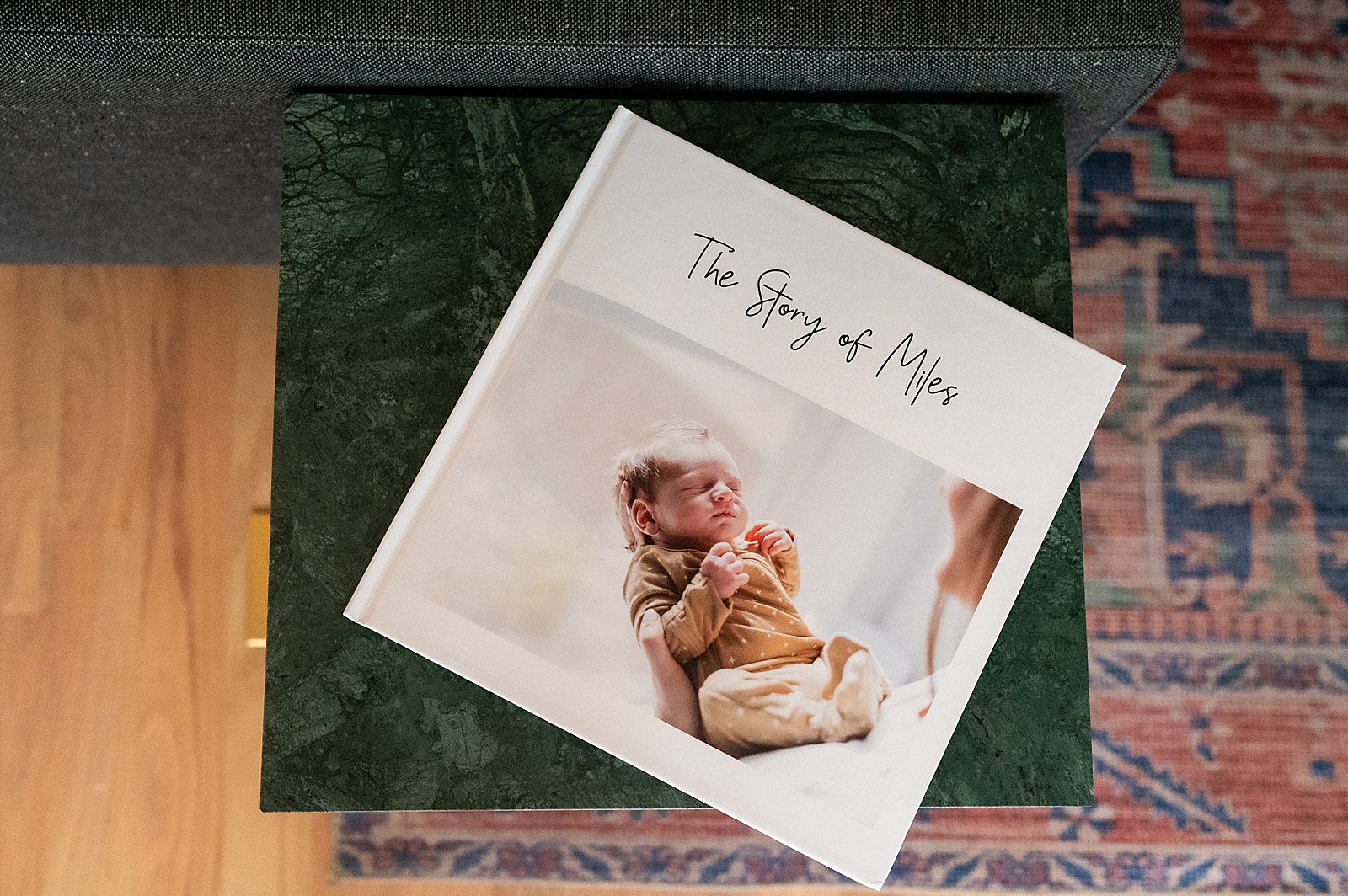 A baby's first year book sits on a green coffee table.