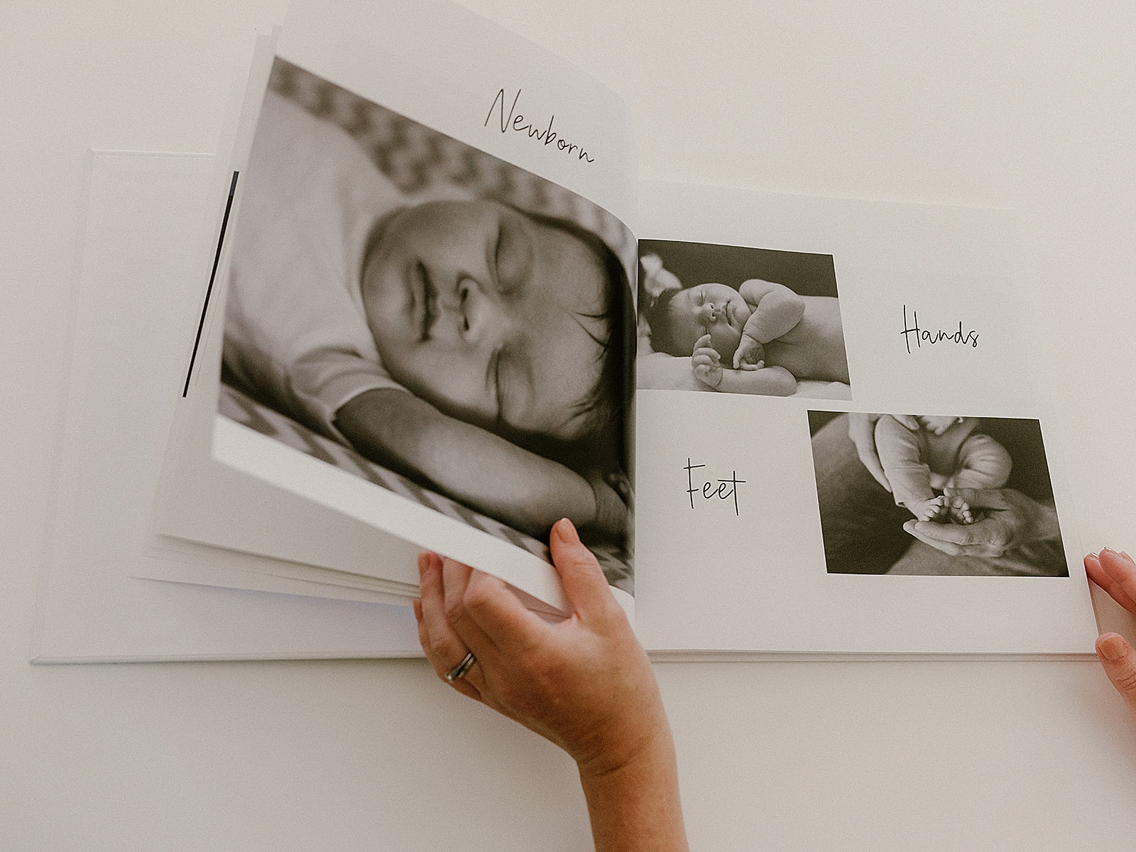 Someone flips through a baby book for a newborn.