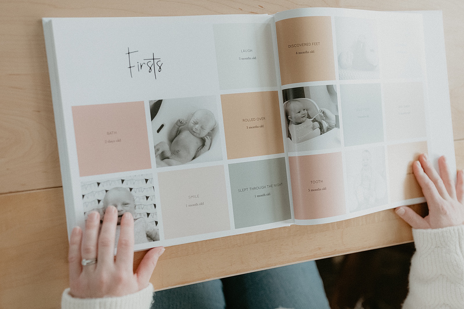 A woman flips through milestone books with photos and text.