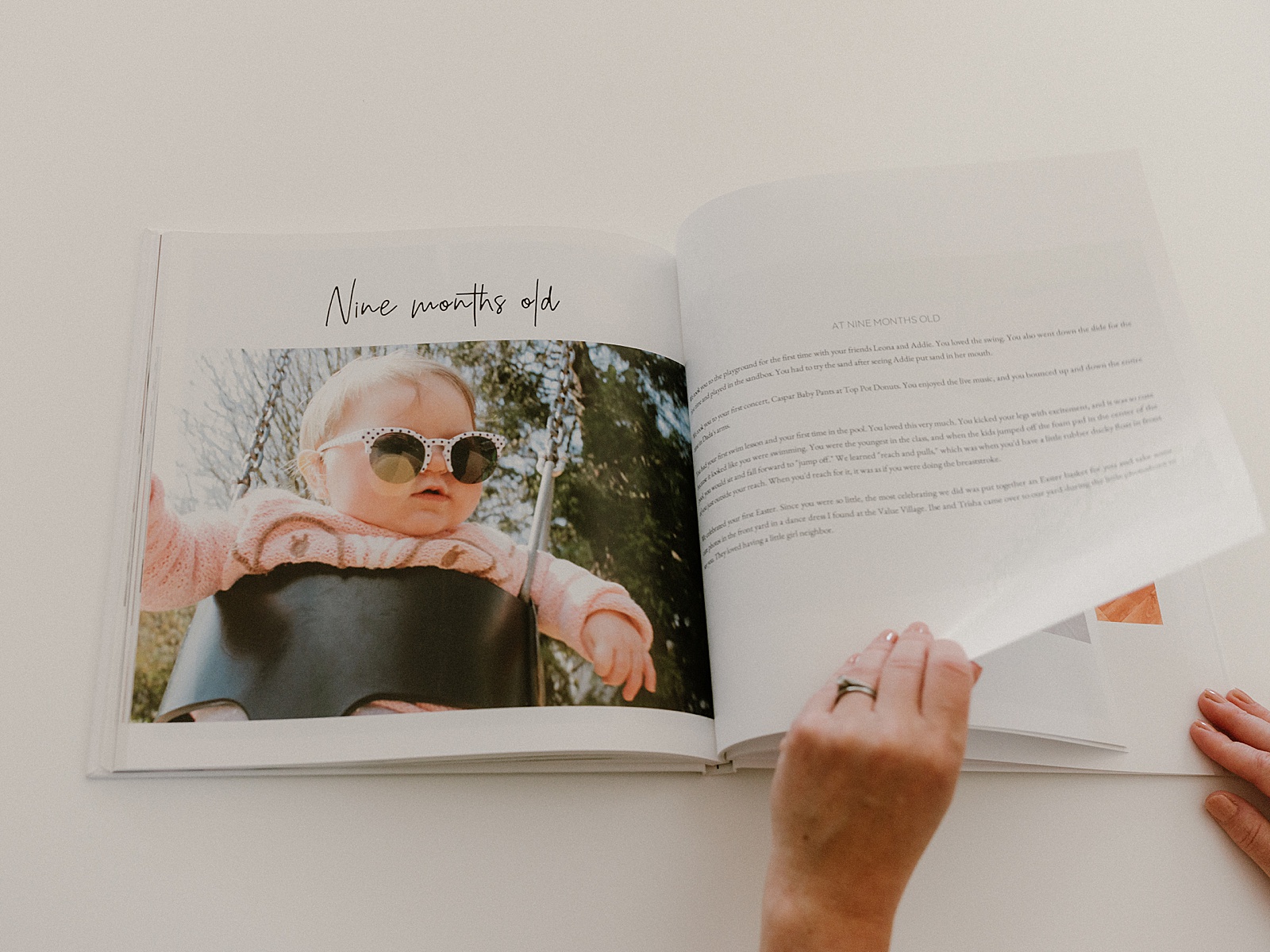 A woman flips through a story in a baby book.