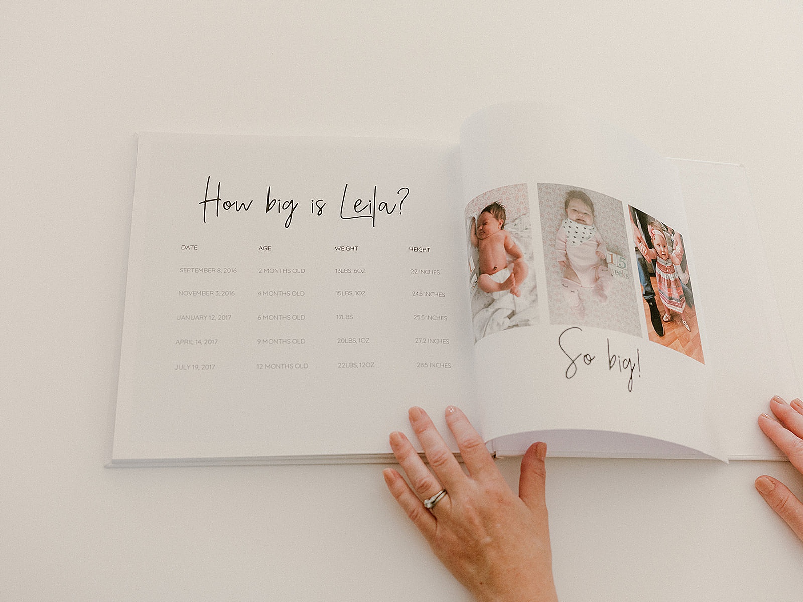 A baby milestone book includes a growth chart beside photos of a baby.