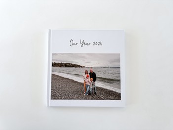 A family photo album sits on a white table.