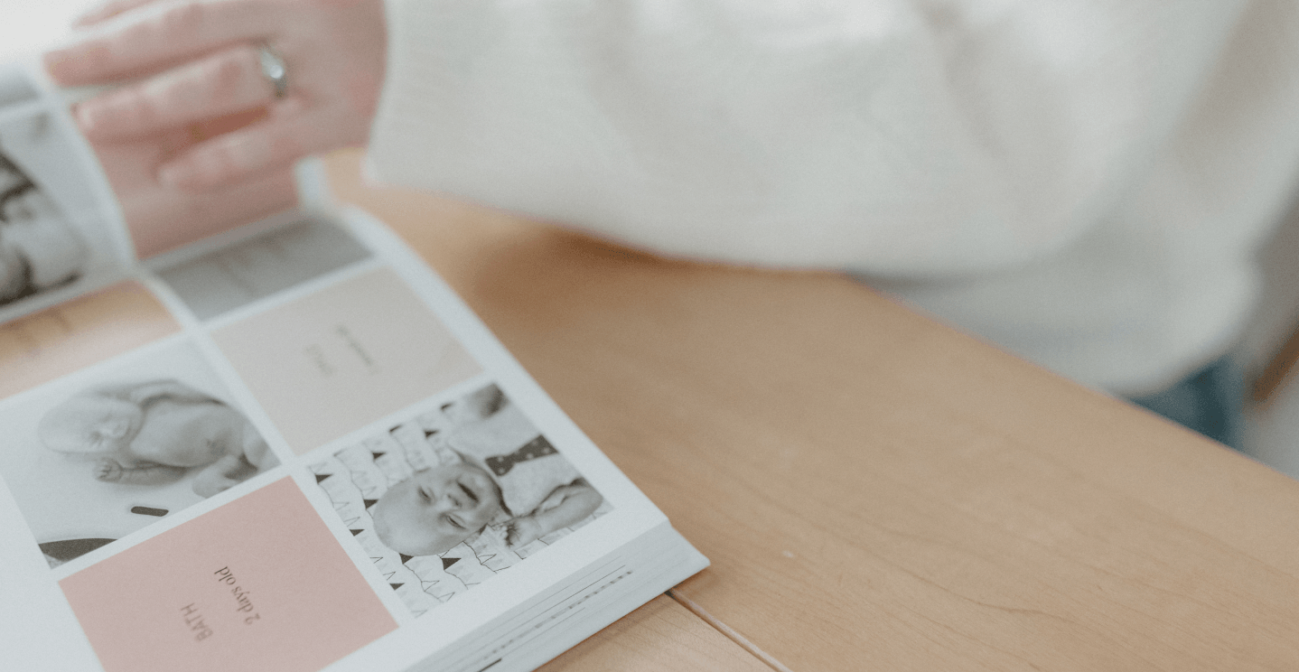 Hand flipping through modern baby book pages